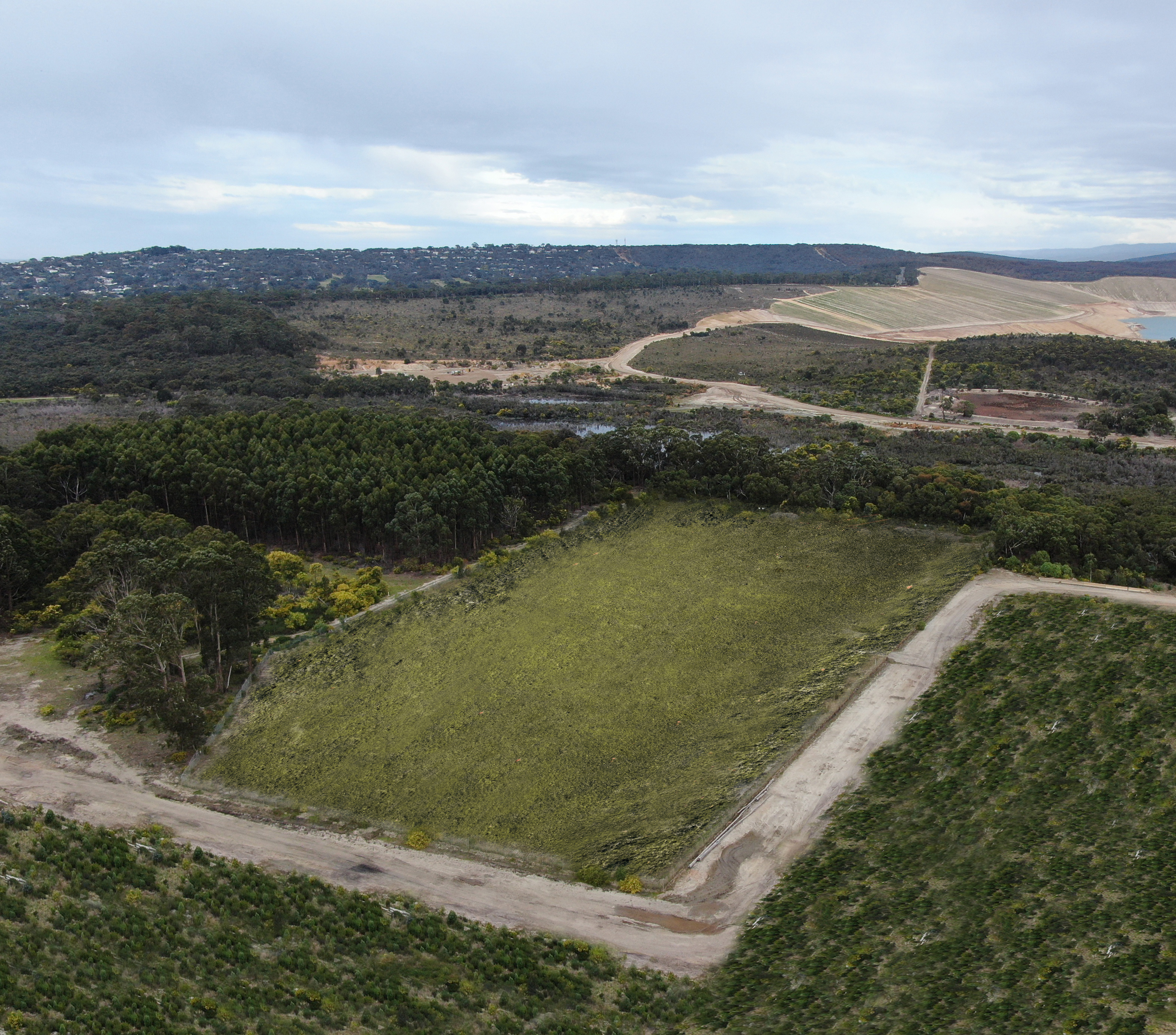 Rectangle section of green grass - former landfill site that has been cappedl